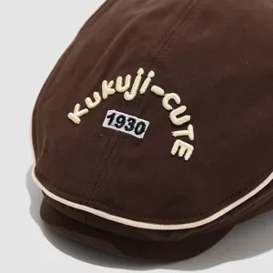 Brown cotton ivy cap featuring embroidered text details and stylish contrast piping design.