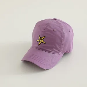 Closeup of purple children baseball cap featuring cute yellow starfish embroidery detail, casual style.