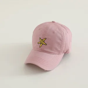 Close-up detail view of cute pink children baseball cap featuring lovely yellow starfish embroidery.