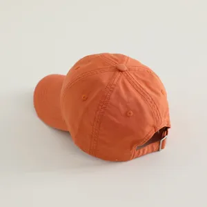 Orange kids baseball cap back detail showing adjustable metal buckle and stitching.