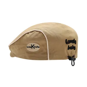 Kids khaki beret hat with side contrast piping, cute embroidery letters and adjustable drawstring.