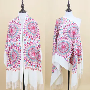 Detailed view of the white ethnic embroidered tassel shawl showing intricate colorful floral patterns.
