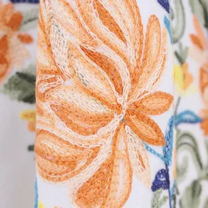 Detailed view of the exquisite orange floral embroidery on the ethnic style cashmere-feel shawl.