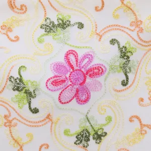 Detailed view of exquisite colorful floral embroidery on soft white fabric shawl scarf