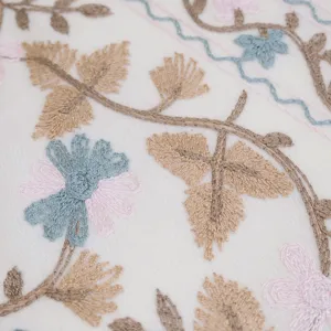 Detailed shot of cashmere-feel embroidered scarf with elegant ginkgo leaves and floral patterns.