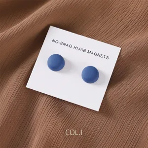 Close-up detail of matte blue magnetic hijab pins on display card, elegant clothing accessory.
