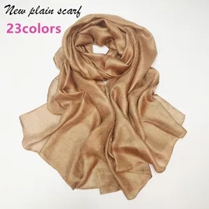 Soft plain colored scarf detail view, elegant gold brown fabric texture, lightweight wrap.