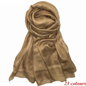 Detailed close-up view of the solid color soft faux silk rolled scarf detail presentation.