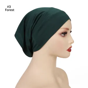 Detailed side view of dark green modal undercap, soft breathable stretchy fabric.
