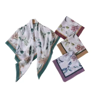 Detailed view of elegant floral print square scarf with wave edges and colorful botanical designs.