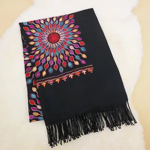 Black cashmere-feel embroidered scarf detail with colorful sunflower pattern and fringe.
