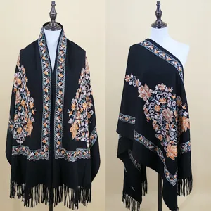 Detailed view of women's black embroidered winter shawl and cozy warm cashmere-feel scarf.