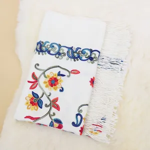 Detailed close-up shot of the white imitation cashmere scarf with colorful paisley embroidery.