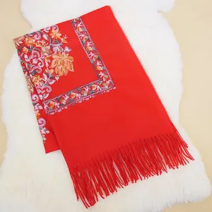 Red cashmere feel winter tassel scarf with ethnic floral embroidery, warm and stylish daily wear.