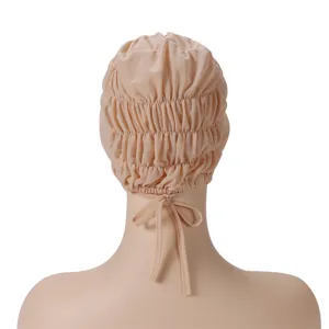 Back detail view of soft beige stretch mesh cap with elastic ruffles and convenient tie string.
