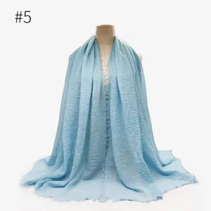 Dettaglio hijab stropicciato azzurro, tessuto in cotone TR testurizzato con bordi sfrangiati.