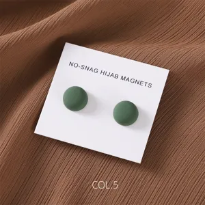 Matte green round magnetic hijab pins detail view, minimalist alloy clothing accessories clasp.