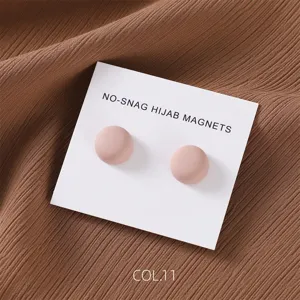 Matte pink round magnetic hijab pins detail shot, secure magnetic scarf clips accessories.
