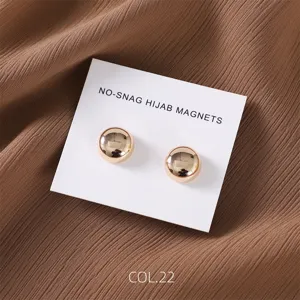 Close-up detail of the round gold magnetic hijab pin set, showing polished finish.