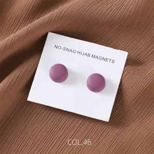 Detail shot of matte purple round magnetic hijab pins displayed neatly on white card.