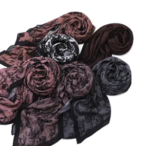 Detailed view of vintage rose print pleated chiffon scarves, multi-color rolled set.