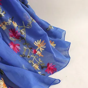 Detailed view of lightweight floral embroidered scarf fabric, showing delicate texture.