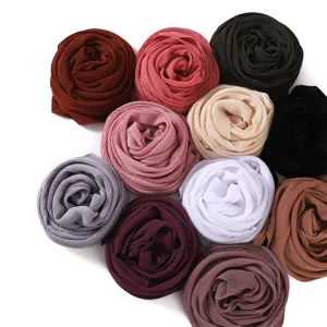 Detailed view of colorful chiffon pleated square scarves with shimmering glitter accents, 90x90cm.