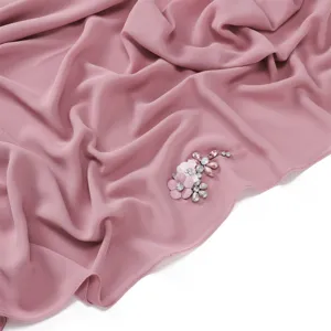 Elegant pink chiffon scarf featuring sparkling rhinestone and floral embellishment for women.