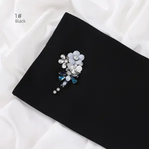 Exquisite handmade rhinestone flower brooch attached to elegant black chiffon scarf accessory.
