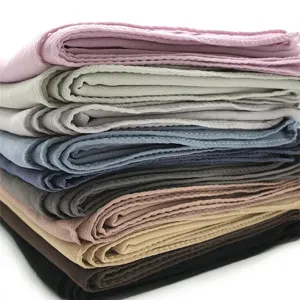 Detailed view of stacked solid color chiffon scarves and hijabs in multiple shades.