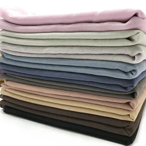 Detailed view of stacked colorful chiffon hijabs showing delicate bubble texture and fabric options.