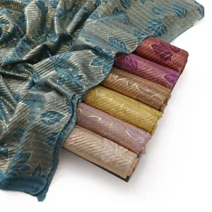 Gold foil leaf crinkle scarf detail, soft breathable cotton linen fabric texture closeup view.