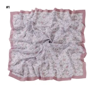 Floral print square scarf detail, pink wavy laser-cut edge hijab shawl closeup.
