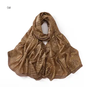 Gold foil leaf printed pleated scarf detail showcasing delicate texture and elegant design.