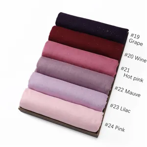 Solid color glitter cotton linen hijab scarf detail showing multiple color variants in tray.