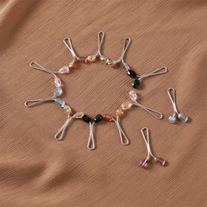 Detailed view of colorful crystal bead U-shaped scarf clips, elegant hijab pins for daily wear.