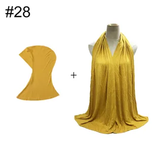 Detail view of soft modal elastic undercap and long scarf set in bright yellow color.
