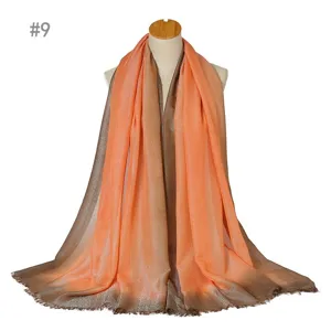 Gradient metallic silver silk scarf detail showing elegant color transition and soft fringes.