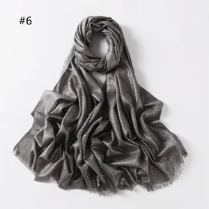 Shimmering metallic viscose scarf detail, elegant silver grey textured fabric with short fringes.