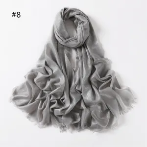 Detail shot of grey metallic shimmering viscose scarf clearly showing short fringe texture.