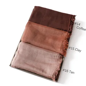 Detailed view of lightweight modal solid color scarves in coffee, clay and tan with fringe.