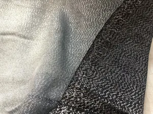 Close-up detail of shimmering metallic rayon silver thread fabric for fashion scarves.