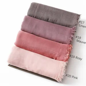 Detail of modal cotton solid color scarf showcasing four elegant shades with fringe edge.