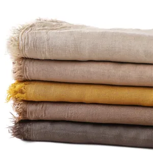 Detailed view of lightweight modal cotton blend solid color scarves with frayed fringe edges.