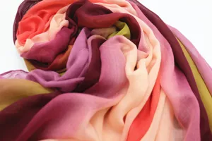Close-up detail of the soft gradient cotton blend scarf showing colorful fabric texture.