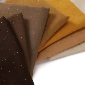 Detailed view of breathable shimmering rhinestone long bali yarn scarf in assorted earth tones.