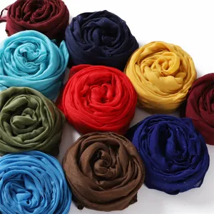 Close-up detail of colorful glitter viscose scarves rolled into beautiful rose shapes.