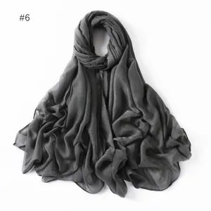 Detailed shot of dark grey glitter viscose scarf, lightweight women's hijab and shawl.
