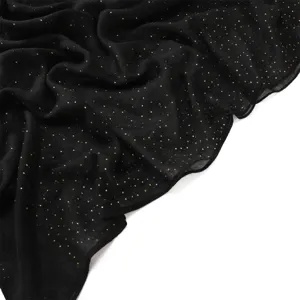 Black starry gold foil balis yarn scarf detail showing soft breathable texture and delicate glitter.