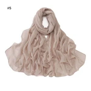 Detailed view of the sparkling rhinestone gauze long scarf, sheer texture, elegant beige.